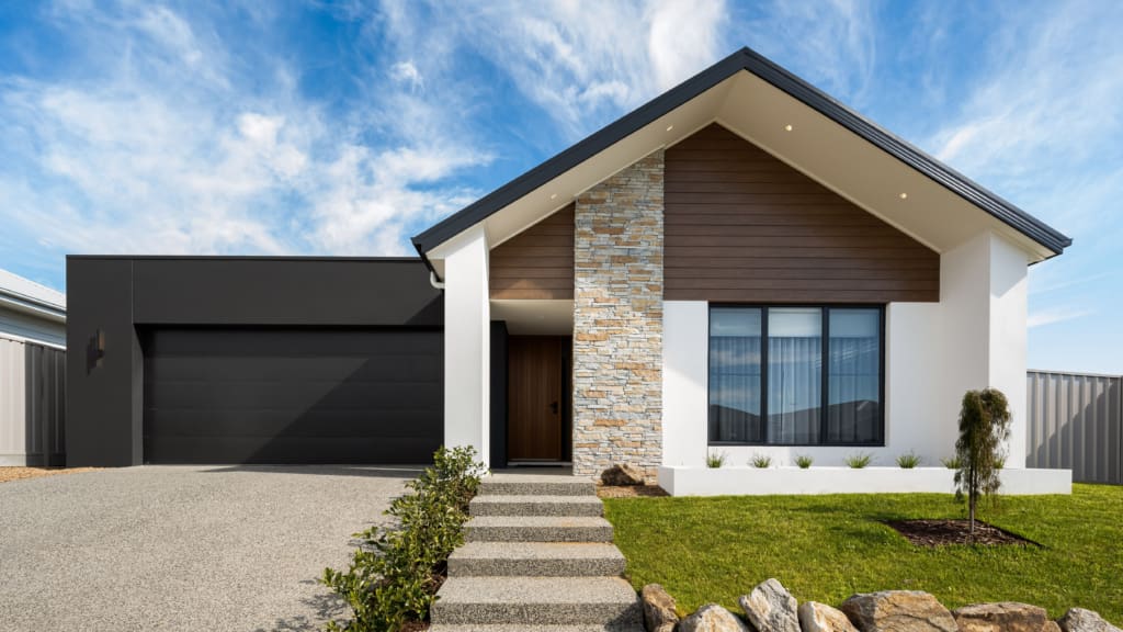 Contemporary display home, black garage, stone column, timber cladding | Davis Sanders